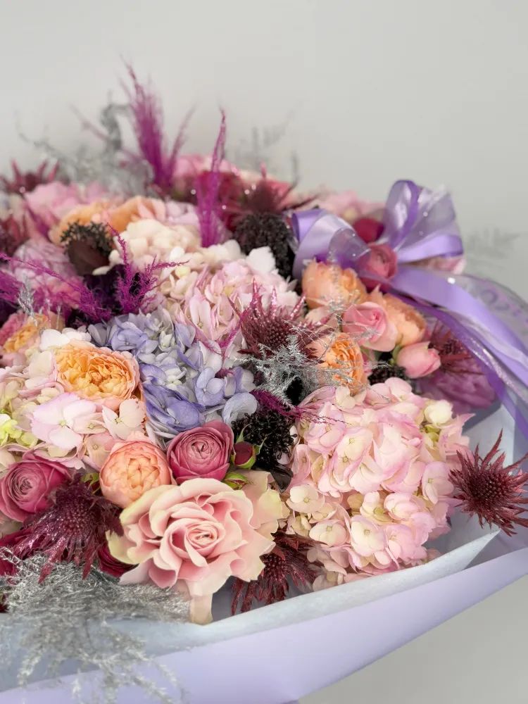 Radiant Pastel Dream: Elegant Hand Bouquet with Purple Accents