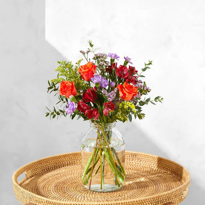 Vibrant Floral Arrangement with Orange Roses and Red Blooms