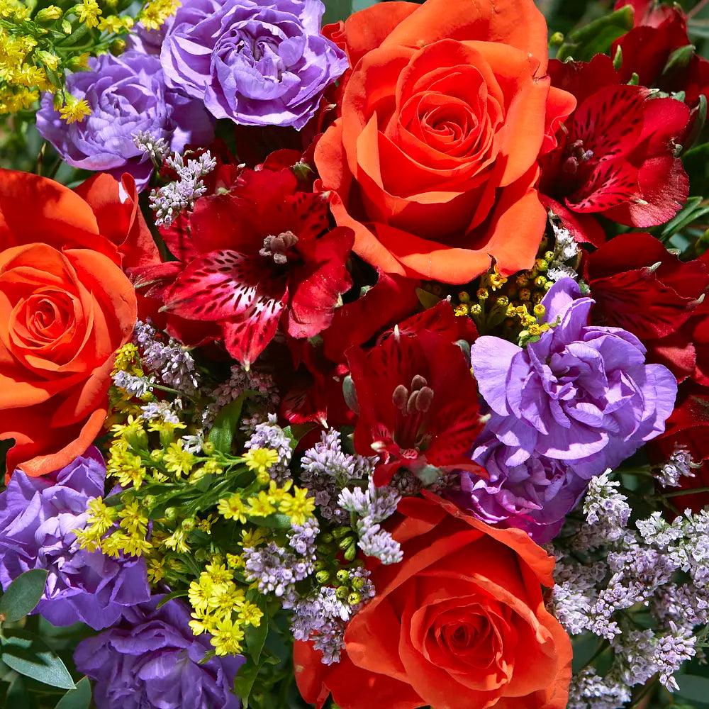 Vibrant Floral Arrangement with Orange Roses and Red Blooms